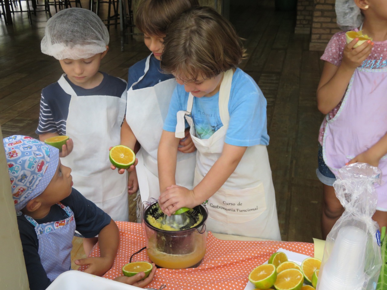 Crianças preparando suco de frutas